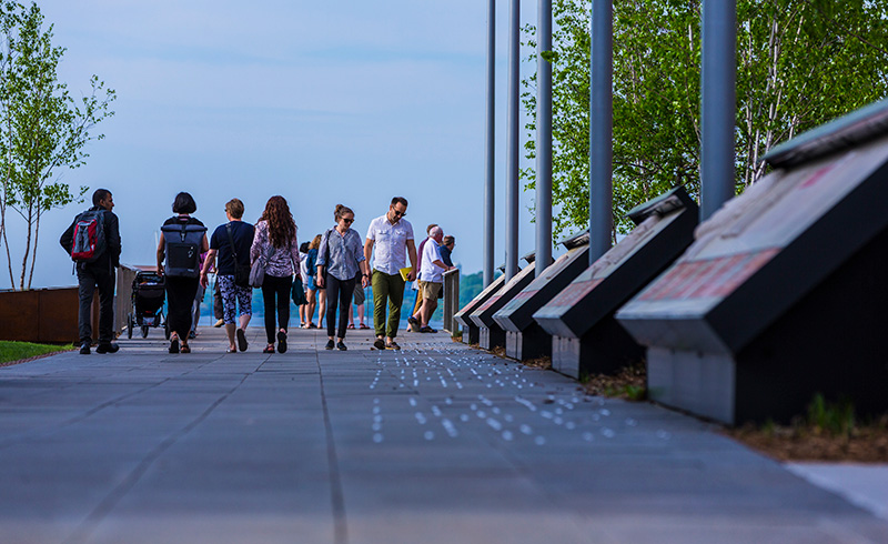 Pedestrians walking through Alumni Park